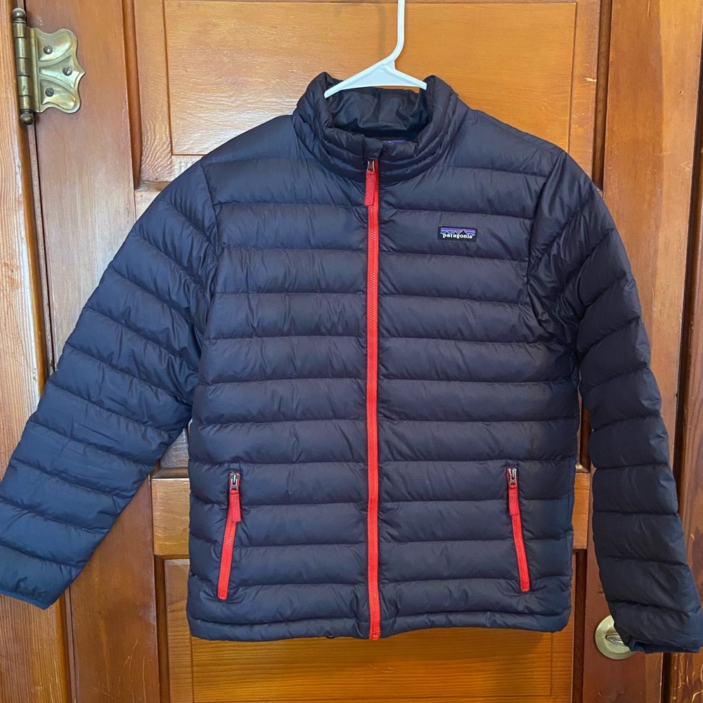 Patagonia Navy Blue Puffer Jacket with Red Trim
Down fill.